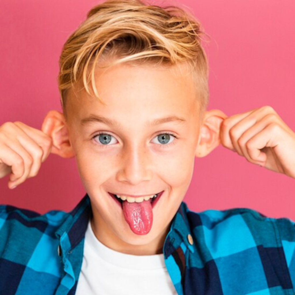 Teenage Boy pulling face tongue out