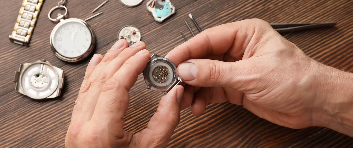 watchmakers hand making timepiece